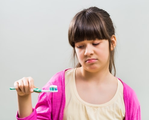 Sad little girl with toothbrush